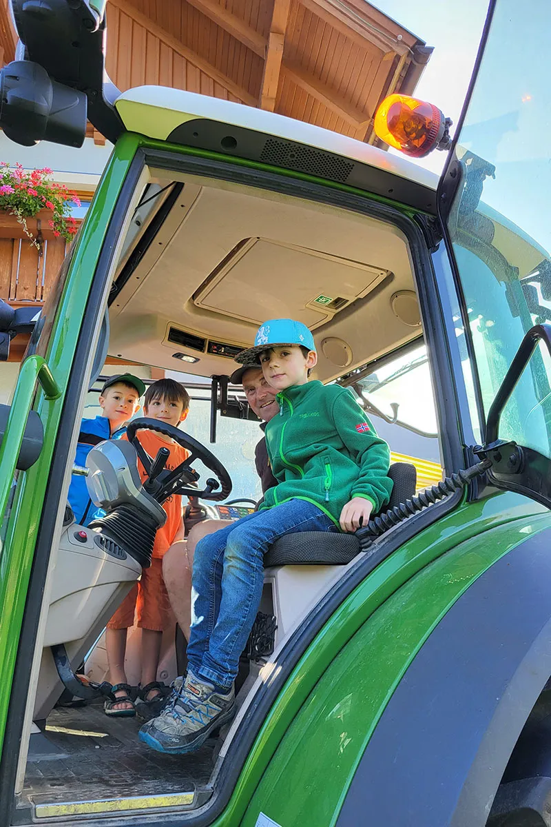 Kinder fahren Traktor am Kinderbauernhof Hansalagut - echtes Landleben erleben